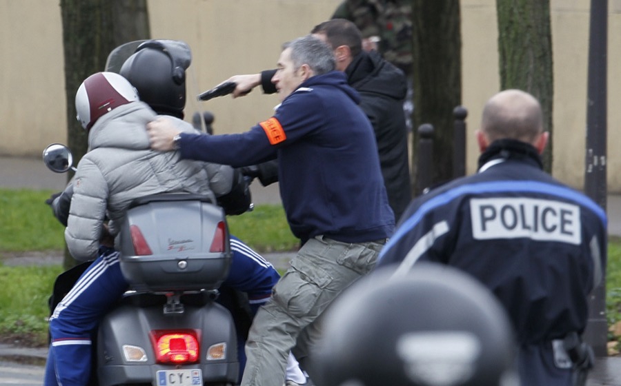 French police forcibly stop at gun point young people on a scooter as they arrive near the scene of hostage-taking at a kosher supermarket near Porte de Vincennes in eastern Paris on Jan. 9, 2015. French police forcibly stop at gun point young people on a scooter as they arrive near the scene of hostage-taking at a kosher supermarket near Porte de Vincennes in eastern Paris on Jan. 9, 2015.